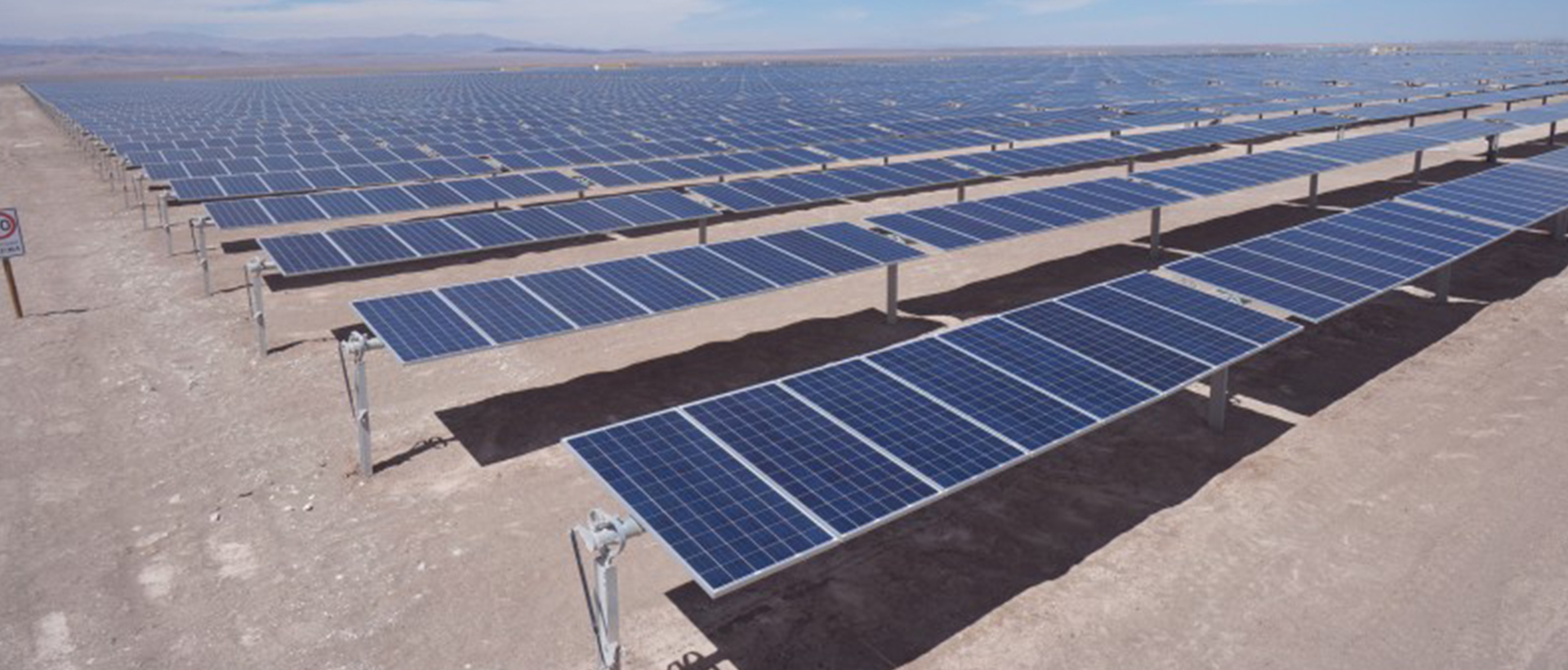Planta solar fotovoltaica con cientos de paneles solares instalados en el desierto para generación de energía limpia